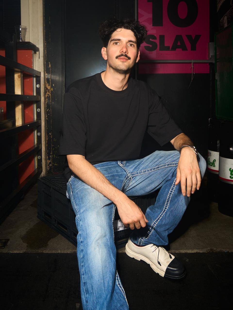 Daniel Vargas seated in a nightlife venue